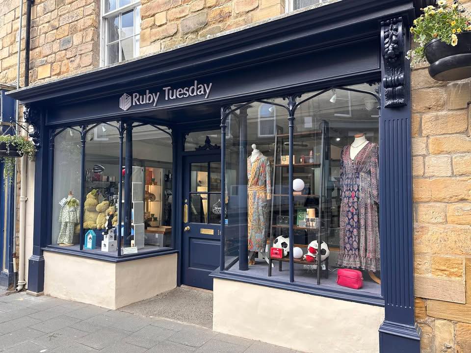 Ruby Tuesday navy shopfront on Narrowgate, Alnwick, with white painted lettering and a small window display